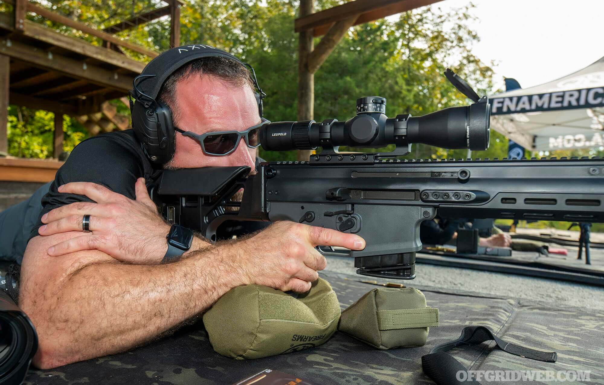 Vibrant SHOT Show 2026 exhibit hall packed with booths showcasing new firearms, attendees testing gear, and massive displays of rifles and pistols.